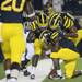 Michigan junior quarterback Denard Robinson kneels in the end zone with teammates senior wide receiver Junior Hemingway and senior tight end Kevin Koger after running in a touchdown during the fourth quarter against Notre Dame on Saturday. Melanie Maxwell I AnnArbor.com